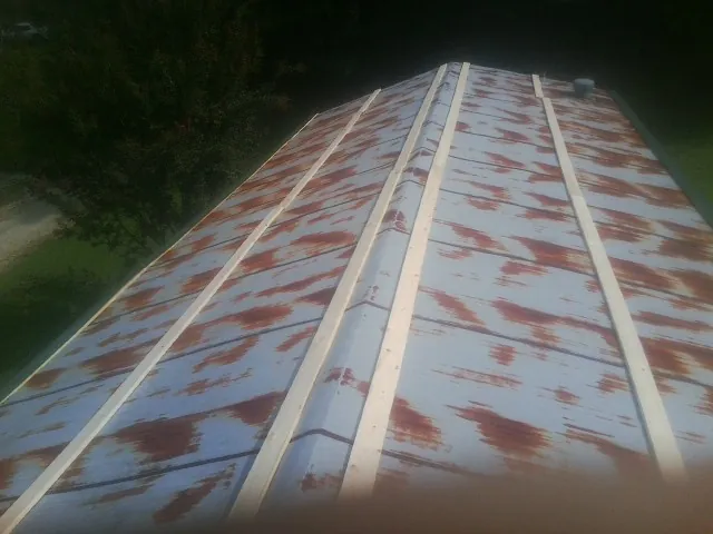 Rusted metal roof panels with new wood purlins before replacement — Storm Damage Roof Repair in Dent by Roofing Brothers
